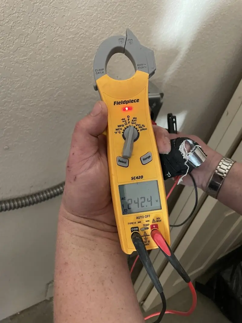 Voltage testing with clamp meter during Recessed Lighting Installation in Wharton